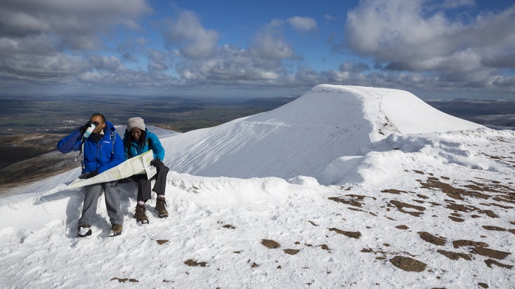Walkers on Corn Du mountain, south west of Pen y Fan in the Bannau Brycheiniog National Park
